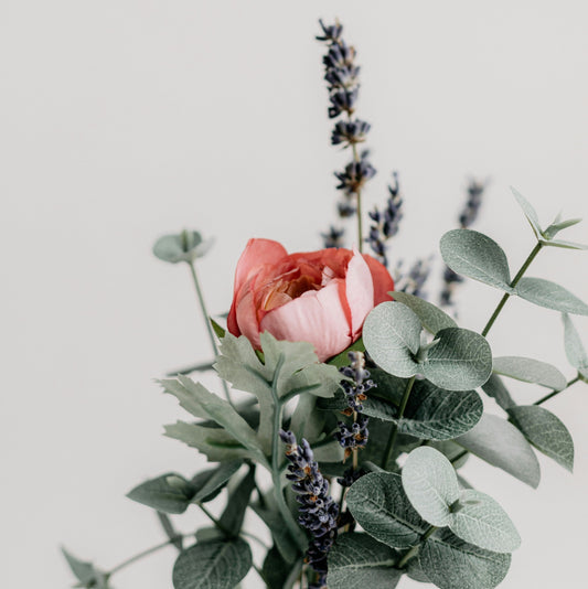 Bunch of eucalyptus leaves, lavender blooms and roses with a white background