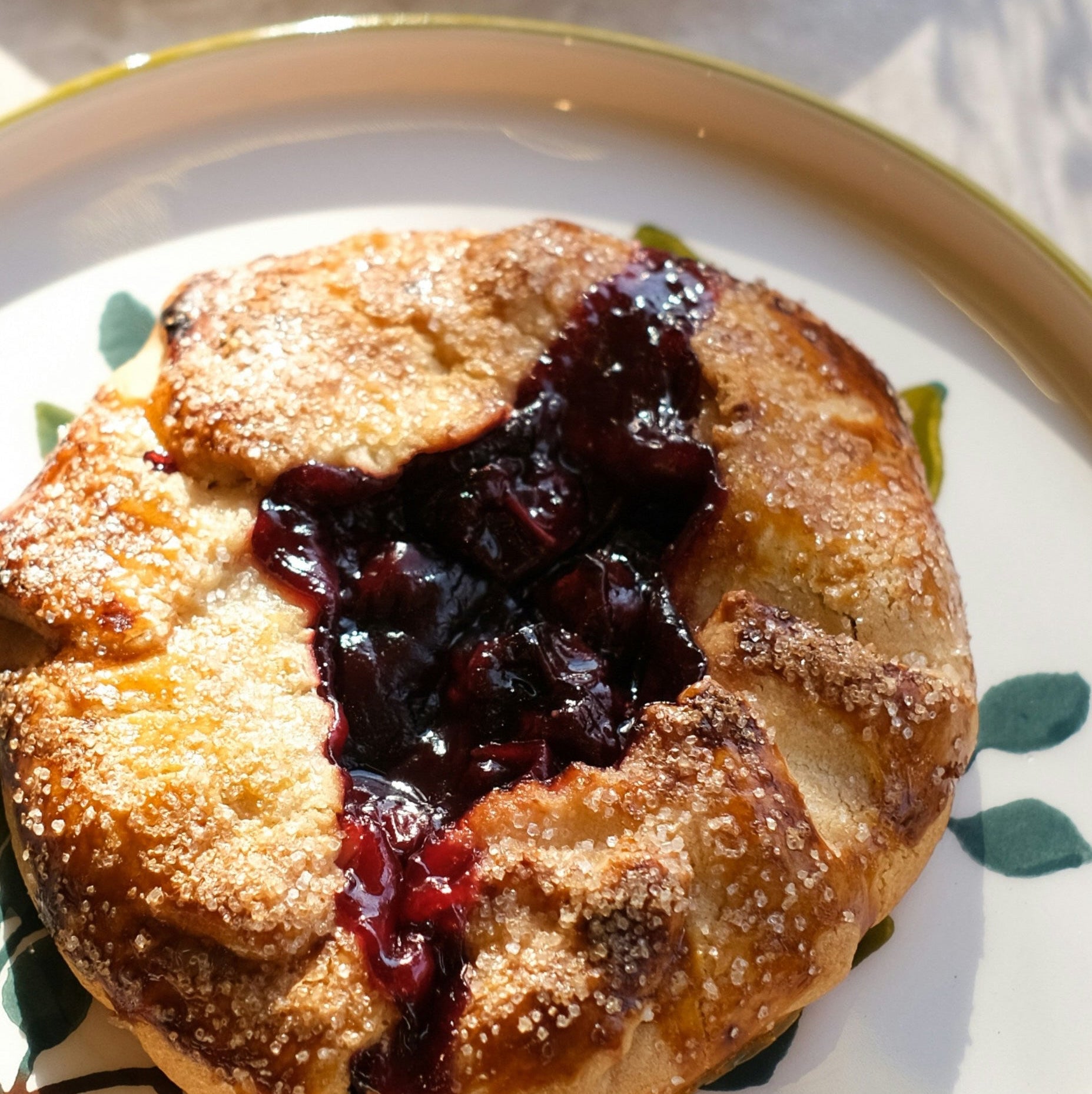 Pastry with berry filling on a decorative plate on a marble surface