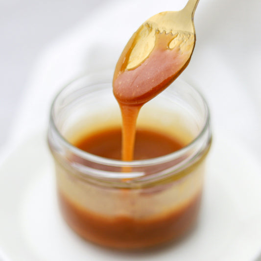 Vanilla Carmel in a glass jar with a gold spoon