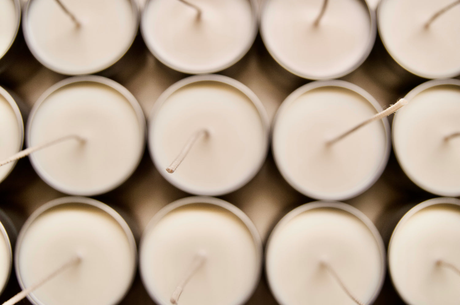 12 candles lined up in three rows of four