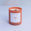 Bliss candle in an orange sorbet coloured frosted glass jar with wooden wick