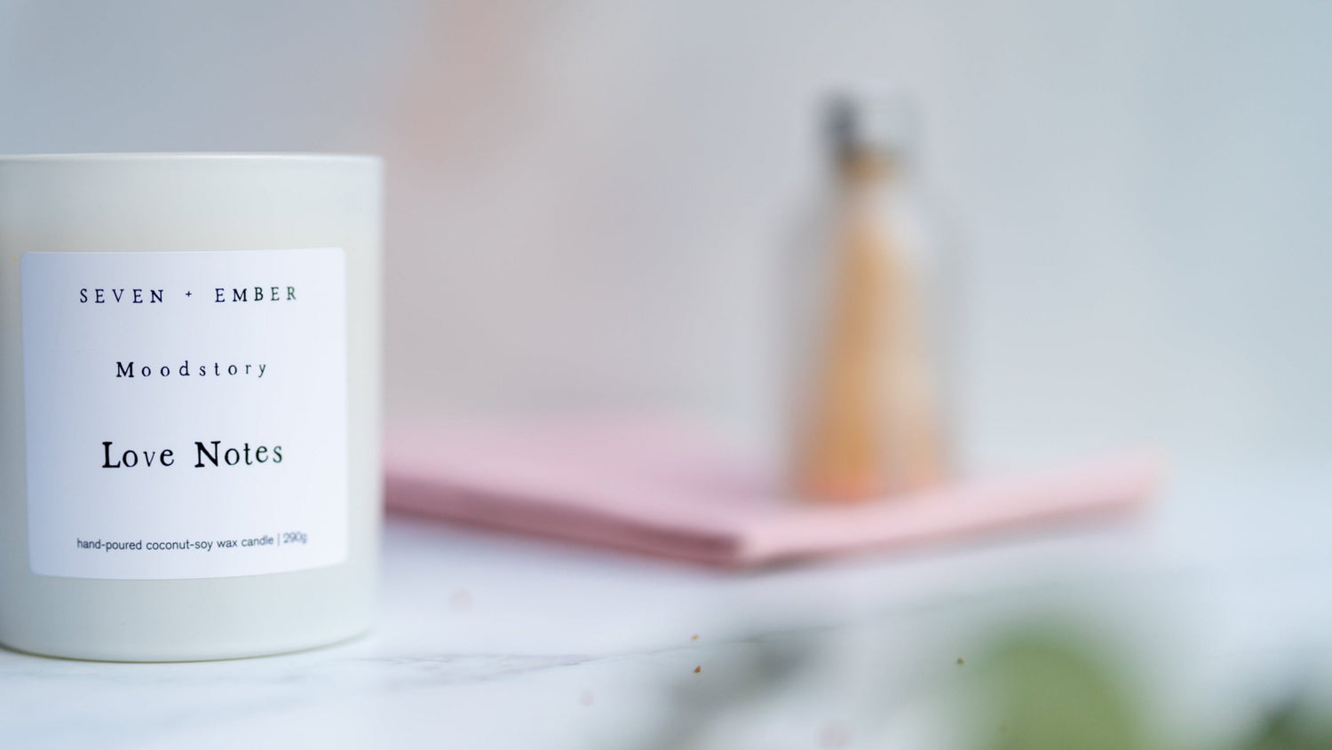 Candle labeled 'Love Notes' on a blurred background