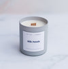 Silk petals candle with a wooden wick in a light grey frosted glass vessel
