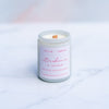 Strawberries and cream candle with wooden wick in a white screw top jar on a marble surface