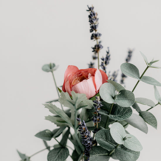 Bunch of eucalyptus leaves, lavender blooms and roses with a white background